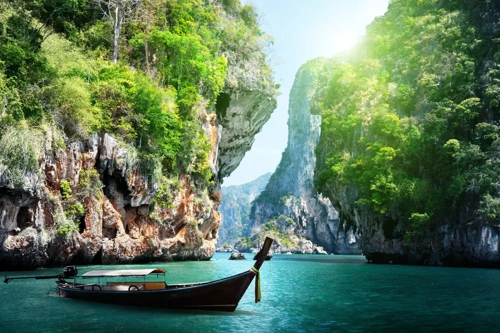 compressed long boat and rocks on railay beach in krabi thailand